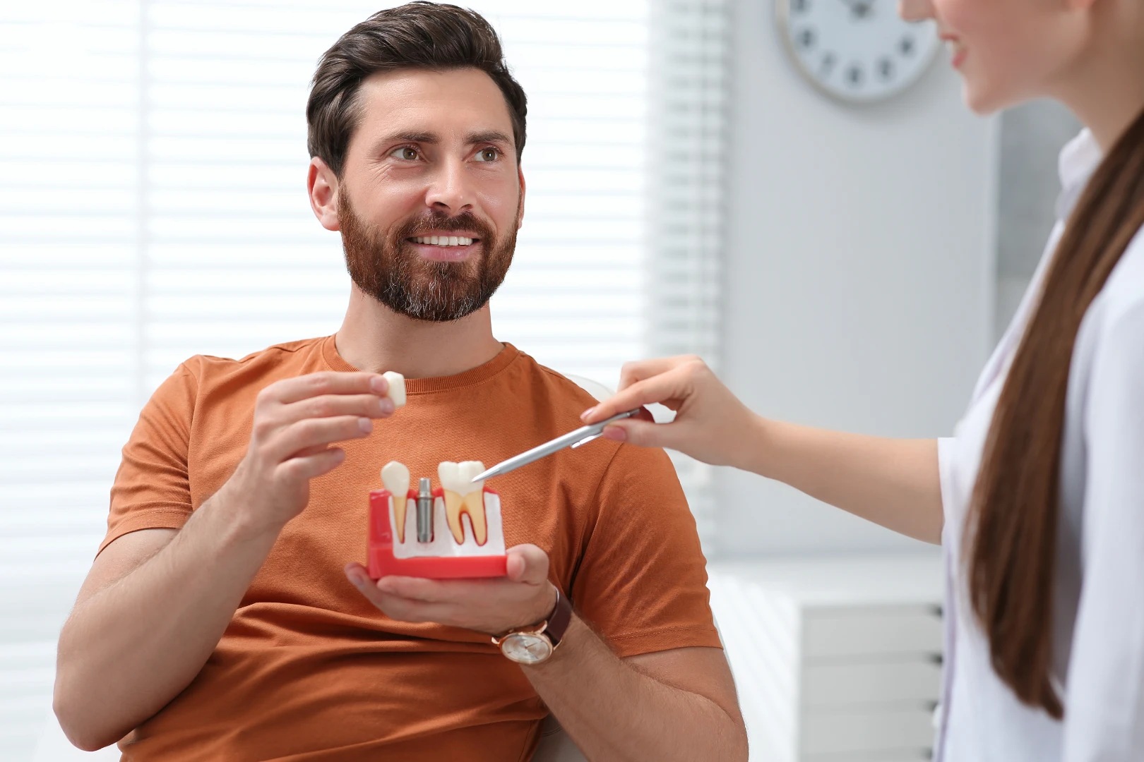 Mature patient smiling after a full-arch All-on-4 dental implant restoration